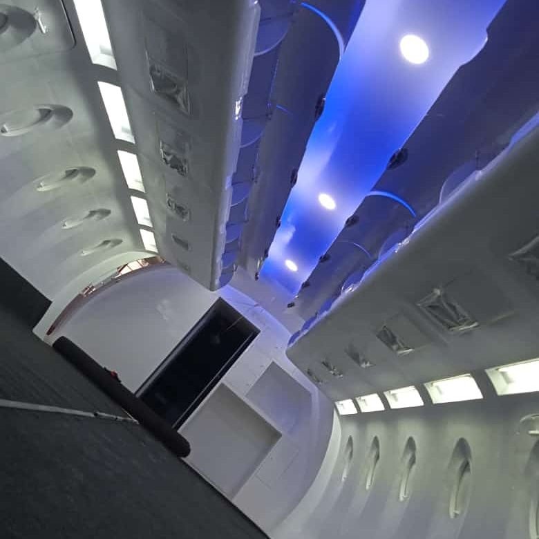 Mood-lit cabin trainer interior, overhead bins and ceiling panel